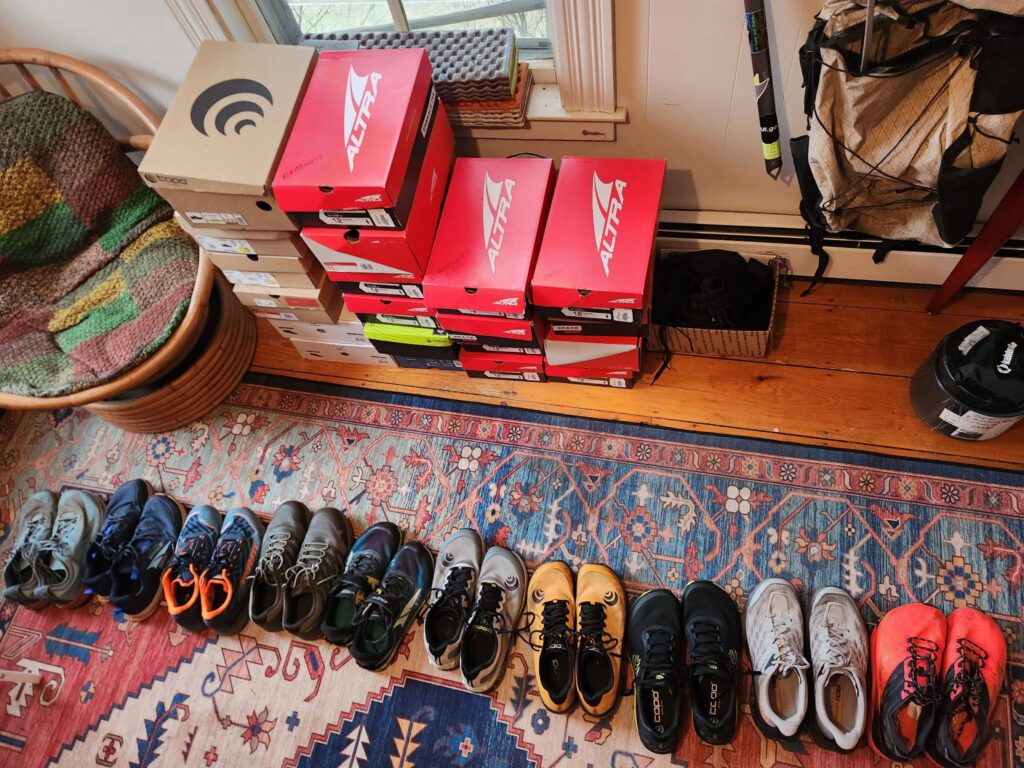 a row of hiking shoes laid out on a floor