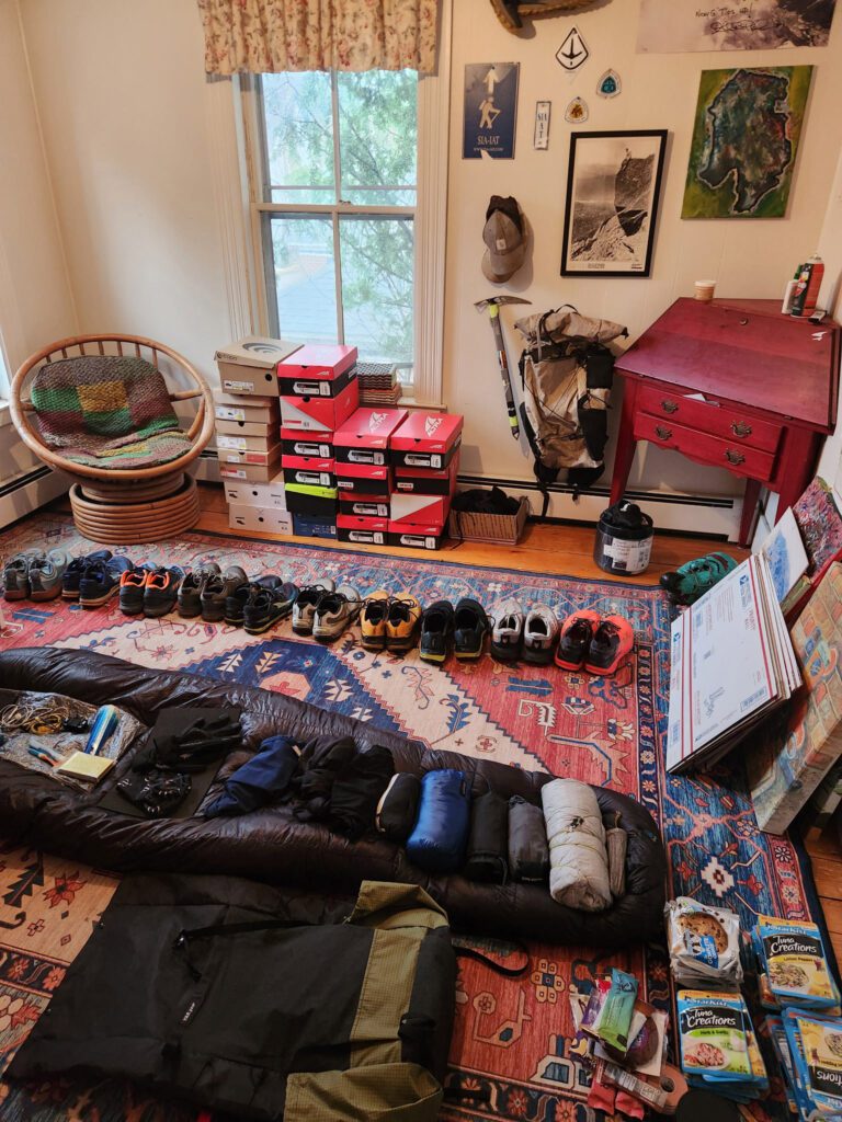 hiking and camping supplies laid out on a floor